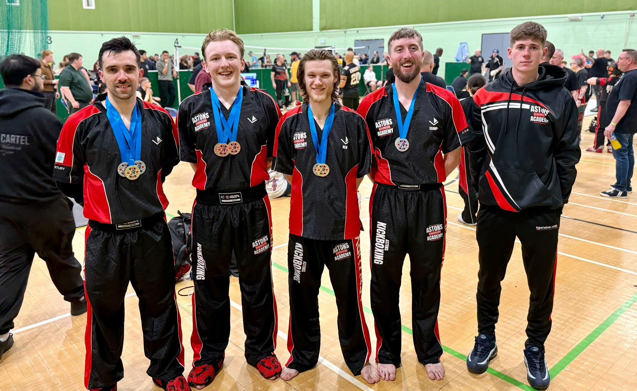 Astons adult kickboxing team with their medals at a competition