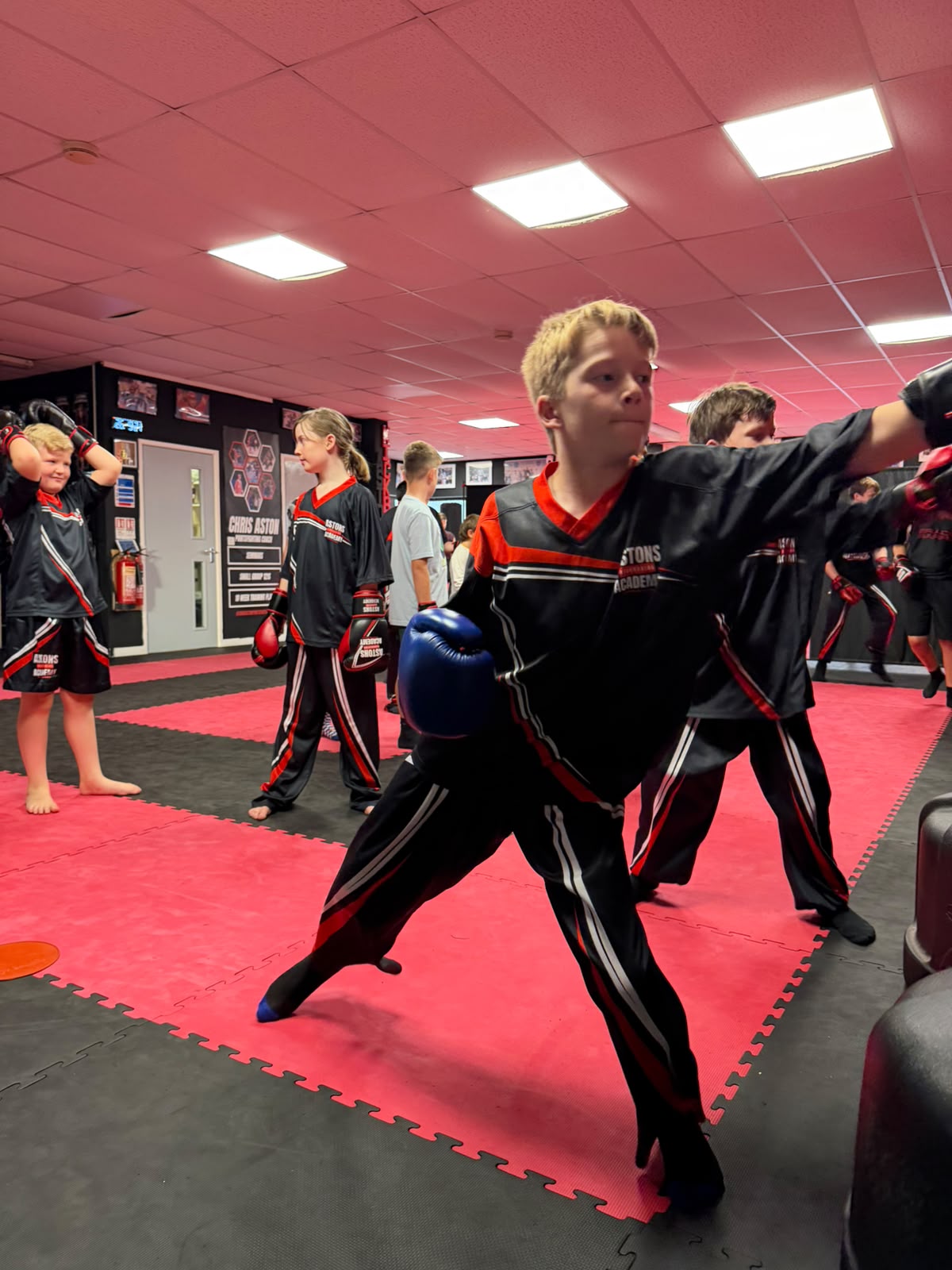 Boy throwing a jab in kids kickboxing class at Astons Kickboxing Academy, Shrewsbury