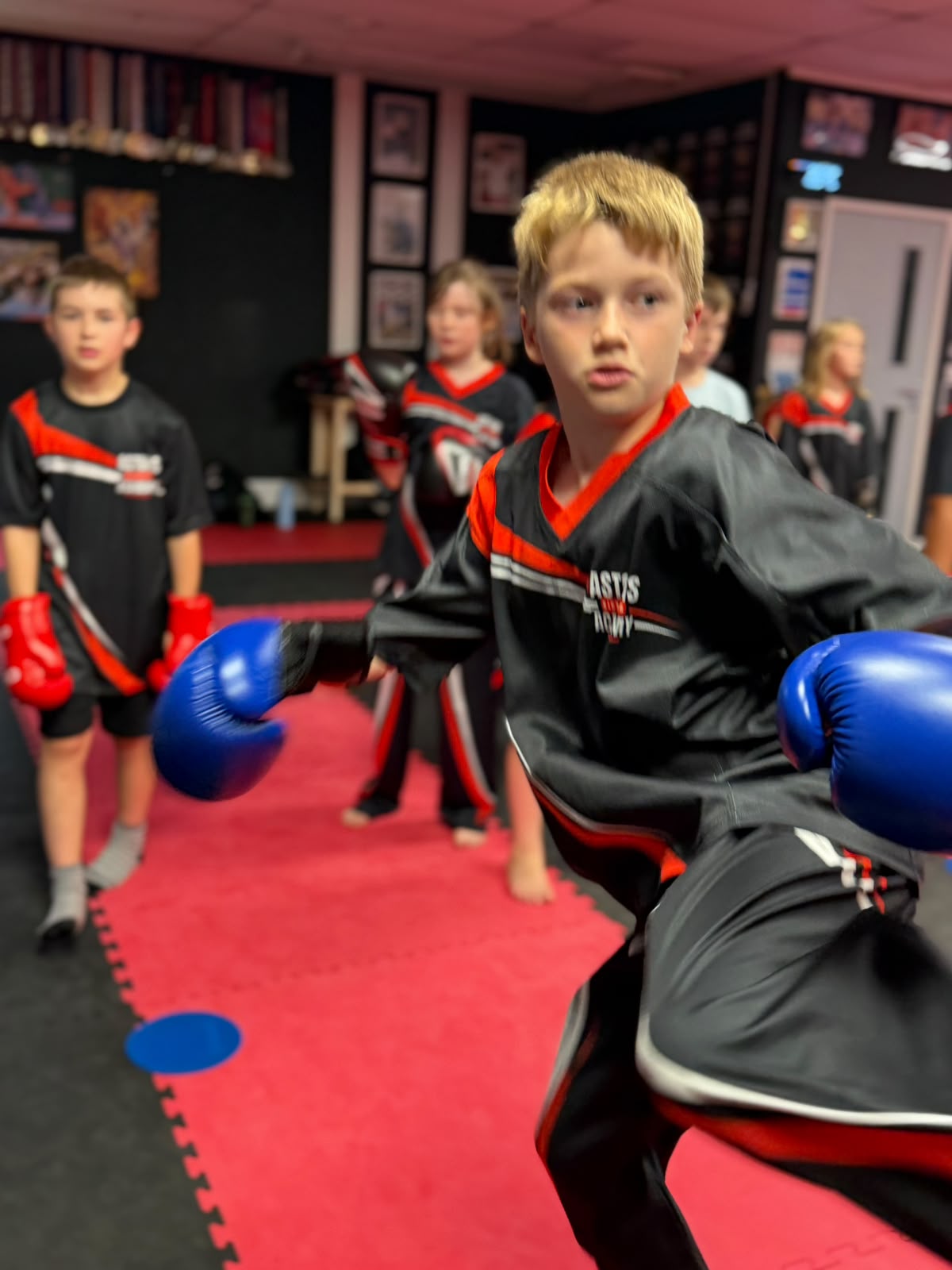 Boy throwing a punch in kids kickboxing class at Astons Kickboxing Academy, Shrewsbury