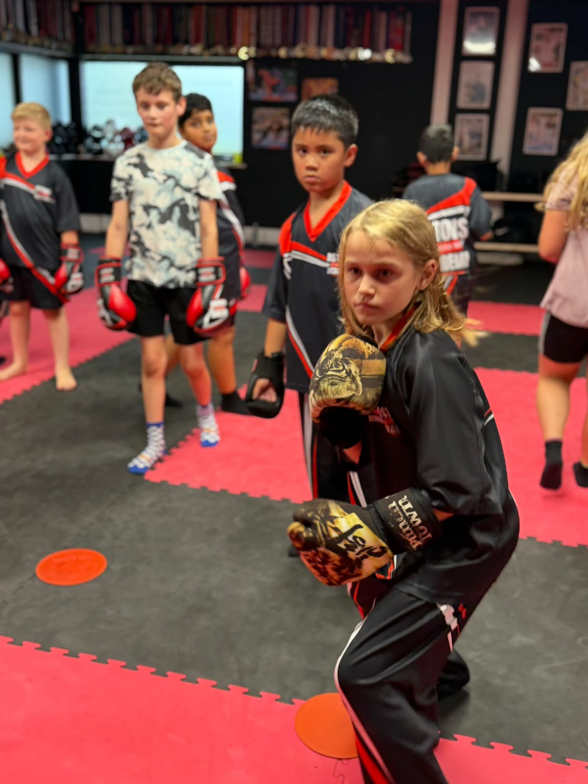 Girl holding a boxing guard in kids kickboxing class at Astons Kickboxing Academy, Shrewsbury
