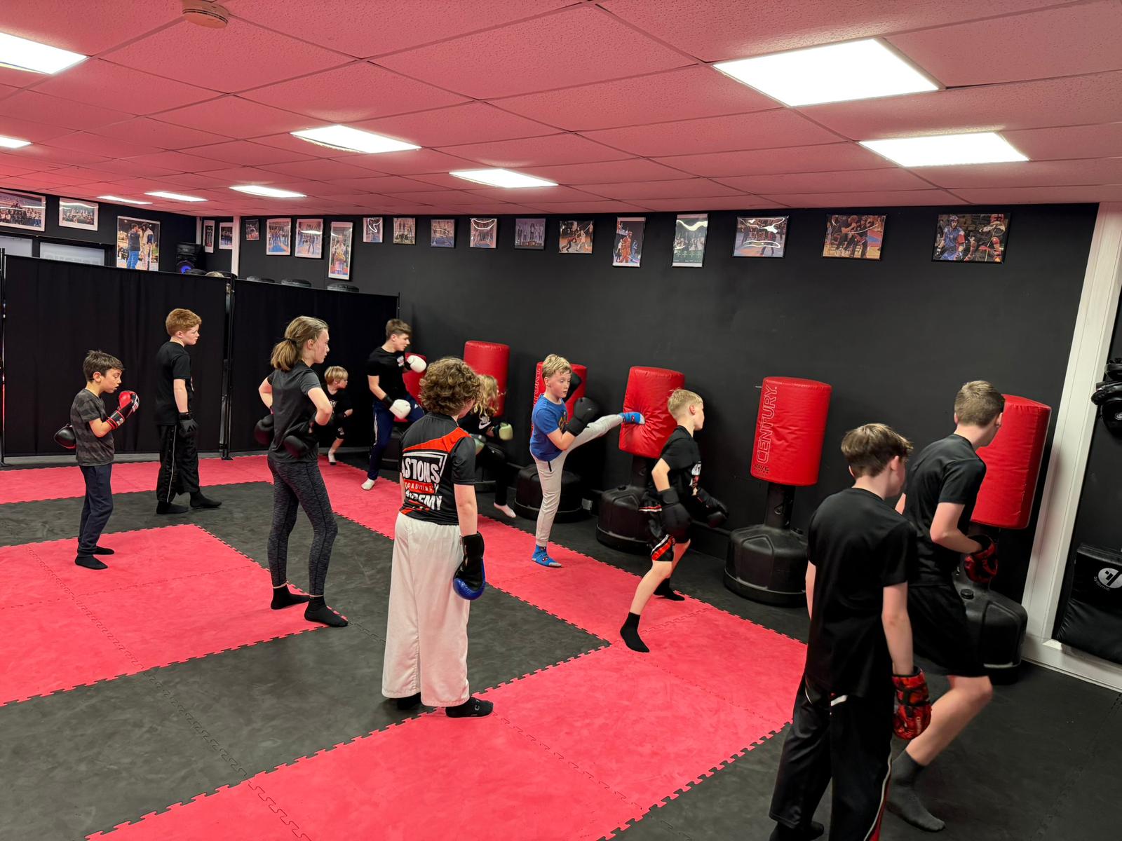 Kids kickboxing class training on the mats at Astons Kickboxing Academy, Shrewsbury