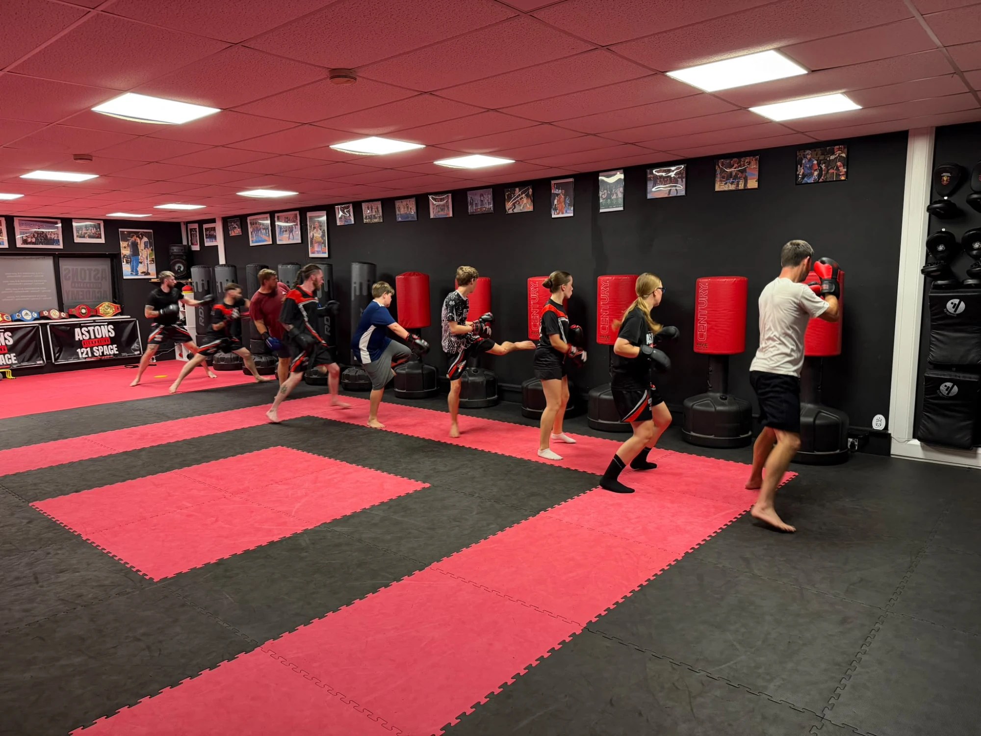 Pads and Bags class lined up working the punching bags at Astons Kickboxing Academy, Shrewsbury