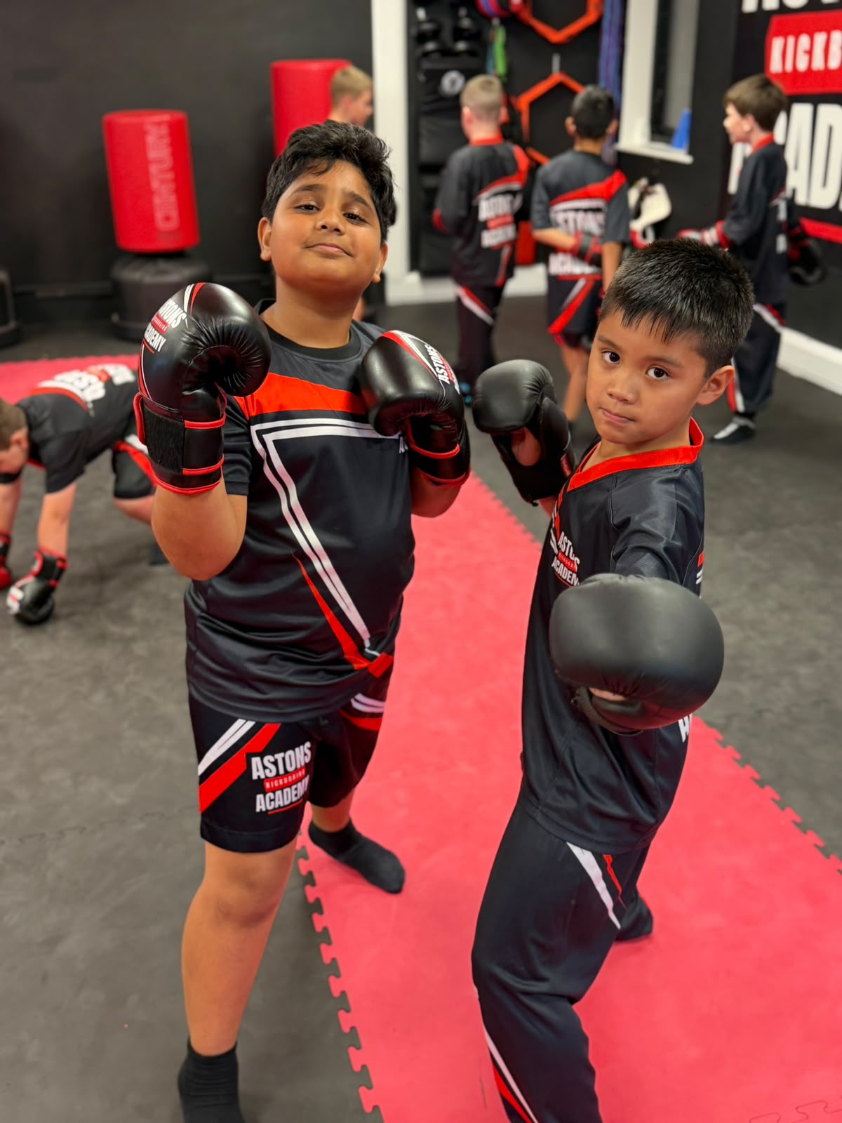 Two boys with their gloves up in kids kickboxing class at Astons Kickboxing Academy, Shrewsbury