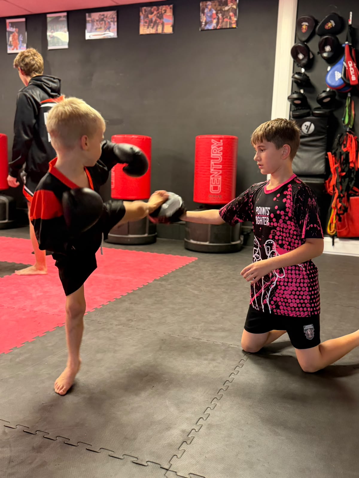 Two boys doing pad work in kids kickboxing class at Astons Kickboxing Academy, Shrewsbury
