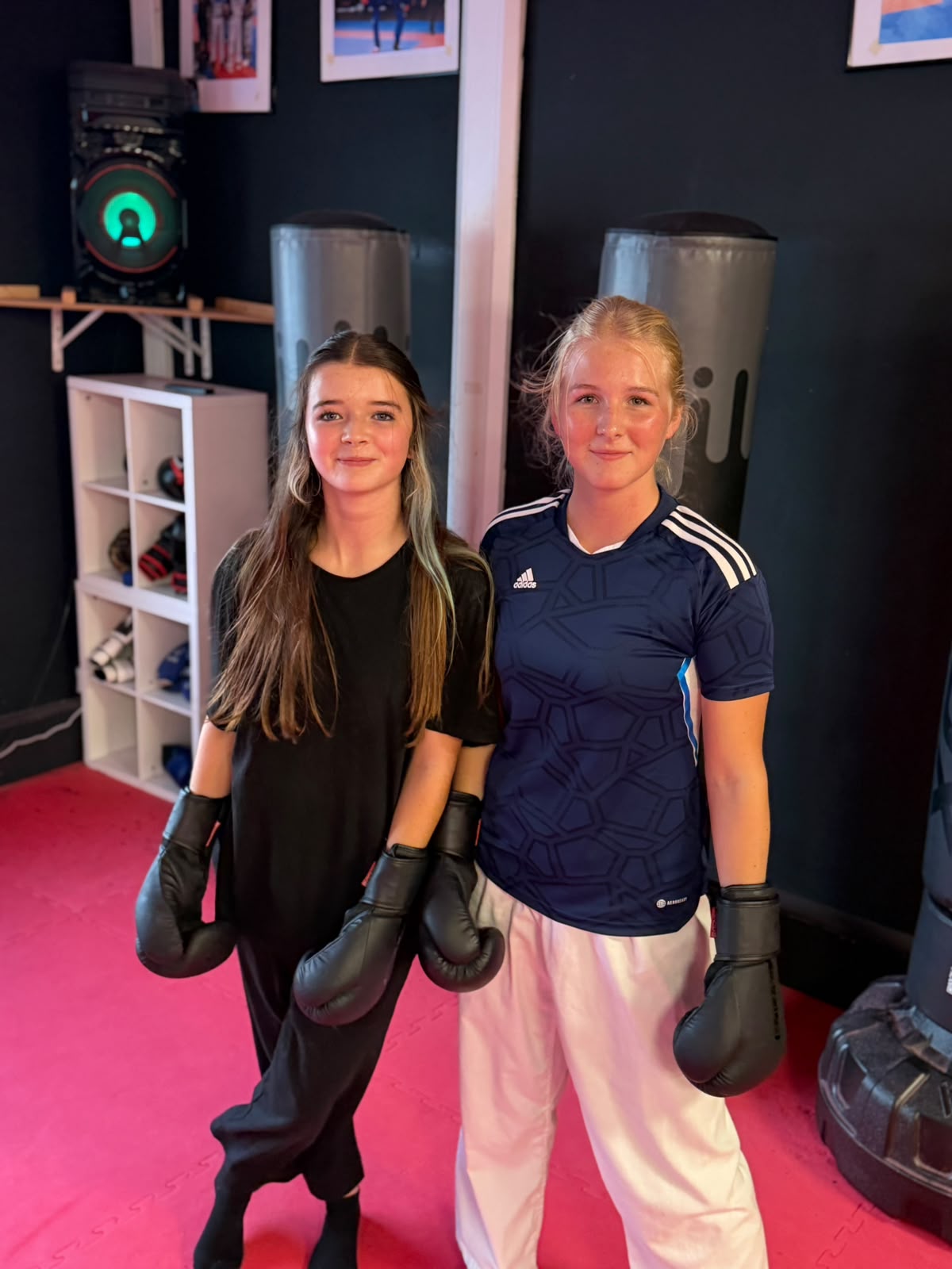Two girls smiling after a kickboxing class at Astons Kickboxing Academy, Shrewsbury