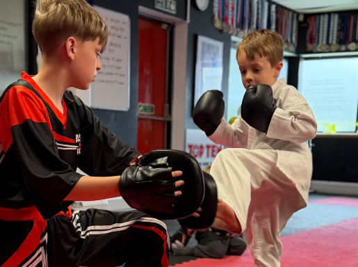 Student with his white belt and certificate at Astons Kickboxing Academy, Shrewsbury
